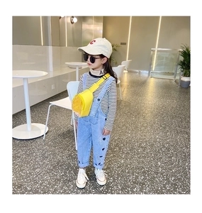 Detail of yellow transparent jelly crossbody bag with quicksand on a stylish child outfit