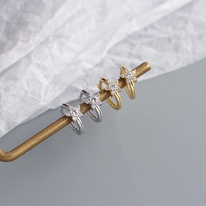 Macro shot of minimalist S925 silver star earrings with zircons in gold and silver