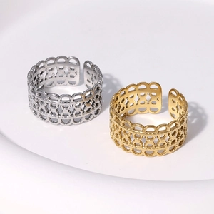 Detailed view of gold and silver hollow lace rings with intricate wave edge patterns