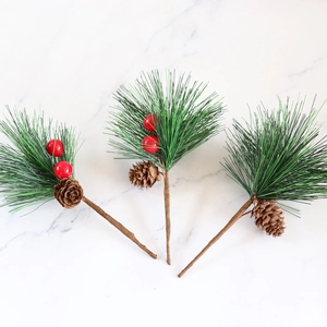 Artificial pine needles with red berries and pine cones for Christmas decoration