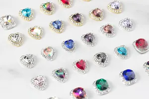 Macro shot of 3D crystal nail art charms in heart and square shapes with rhinestones