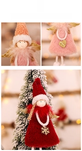 Detail of plush Christmas angel ornaments with gold wings and knit hats on a tree