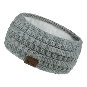 Detail of grey cable knit headband featuring warm white fleece lining and MOK leather label