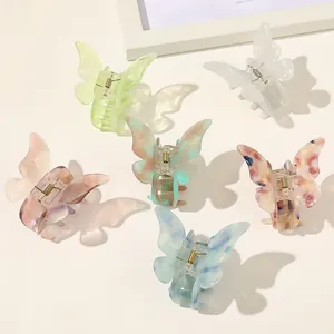 Detailed flat lay of butterfly hair claws in six colors with elegant shadows