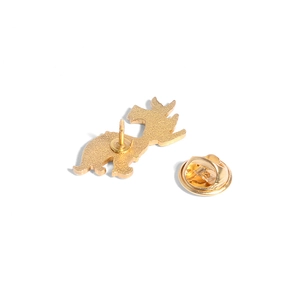 Golden dragon metal pin badge with butterfly clutch back shown on white background