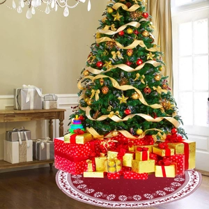 Red knitted Christmas tree skirt with white reindeer and snowflake patterns and gift boxes