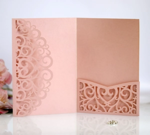 Detailed laser-cut pattern on pink pearl paper wedding invitation sleeve with floral hollows