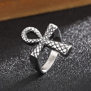 Macro detail of retro stainless steel Ankh ring featuring embossed snake scale texture