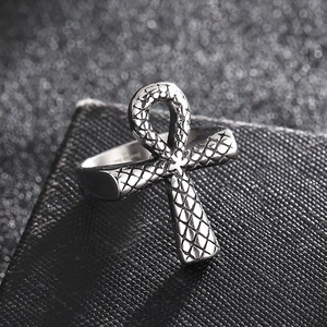Macro shot of silver Ankh cross ring with snake scale texture on a black leather stand