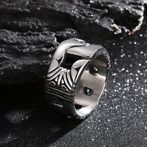 Punk silver stainless steel hollow engraved ring set on a dark textured background