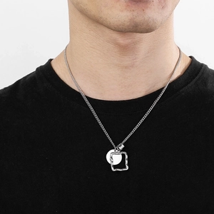 Men's silver titanium steel necklace featuring a round pendant and square frame on model