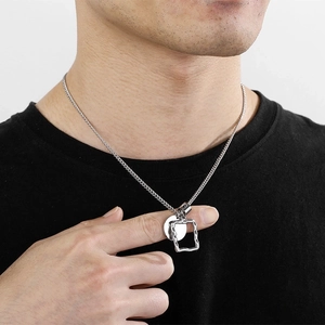 Close-up of minimalist titanium steel necklace featuring a round tag and rectangular frame