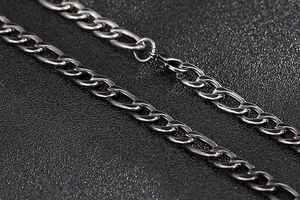 Detail of vintage silver Figaro style stainless steel chain necklace with flat links