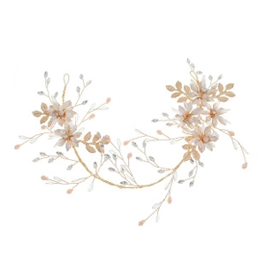 Detailed view of handmade bridal headband with gold wires, pink flowers and crystals