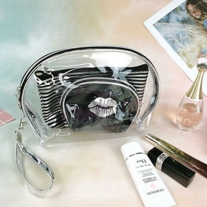 Detail of laser PVC makeup bag with silver lip pattern and striped inner pouch