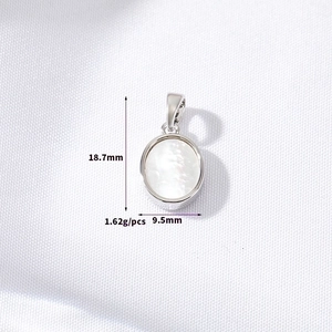 Macro shot of oval white shell pendant in silver showing 18.7mm height and 9.5mm width details