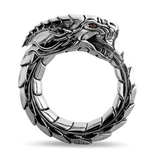 Macro view of vintage silver dragon ring featuring detailed scales and red crystal eyes