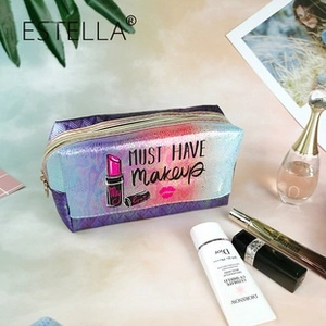 Detail of laser gradient makeup bag with gold zipper and MUST HAVE printed text
