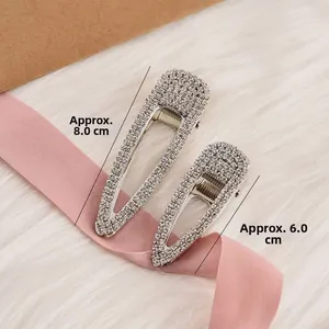 Detail view of silver metal hair clips with rhinestones in 8.0cm and 6.0cm sizes
