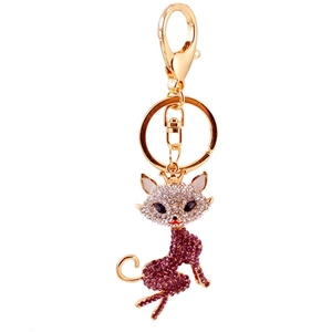 Golden fox keychain with pink rhinestones and small crown on clean white background