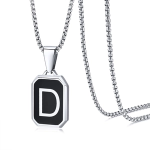 Detailed view of silver octagon pendant with black inlay and white letter D on box chain