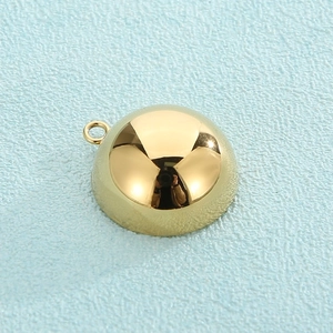 Close-up of a semi-circular gold plated stainless steel DIY jewelry pendant charm