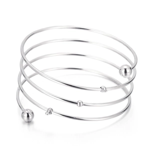 Detail of minimalist five-layer silver spiral bracelet with polished bead accents