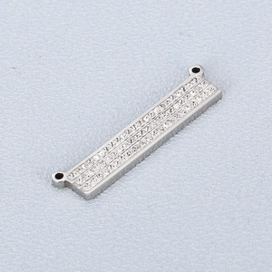 Detailed view of silver rectangular pendant with three rows of sparkling clear zircons