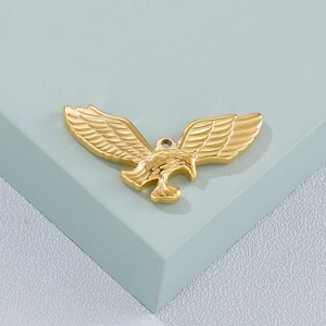 Detailed close-up of a golden eagle pendant showing metallic texture and craftsmanship