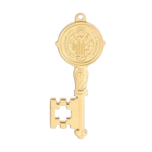 Detailed close-up of a gold Saint Benedict key pendant with engraved cross pattern