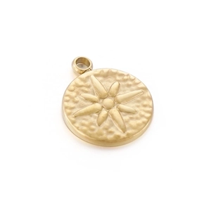 Detailed view of golden stainless steel round pendant with embossed starburst and hammered texture