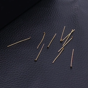 Flat head gold stainless steel pins for DIY earring making on black leather texture