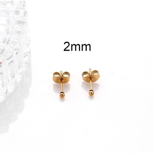 Detailed view of 2mm golden stainless steel ball stud earrings on a clean white background