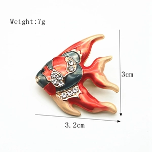 Detail of fish brooch with red enamel and rhinestones, dimensions 3.2cm by 3cm