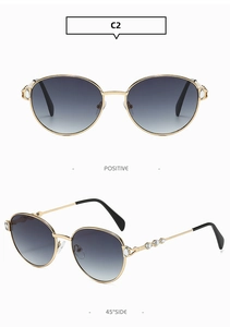 Détails de lunettes de soleil en métal avec verres dégradés et strass sur les branches