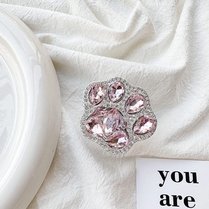 Close-up of luxury cat paw phone grip with pink crystals and silver rhinestone accents