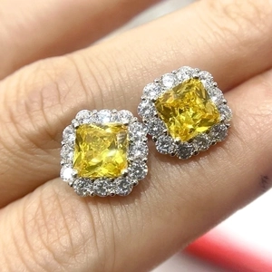 Elegant square yellow gemstone stud earrings with a halo of white diamonds
