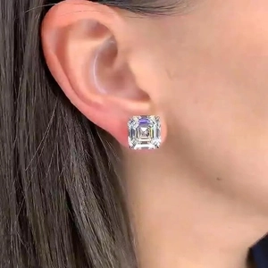 Princess cut square stud earrings with clear white stones on model in classic silver tone