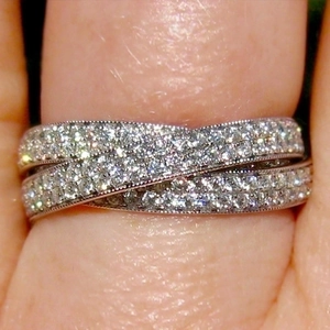 Elegant multi-layer micro-paved crossover ring in silver finish with sparkling stones