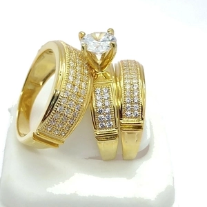 Elegant gold 3-piece wedding ring set featuring round solitaire and pavé cz bands