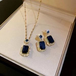 Vintage jewelry set with dark blue gemstone necklace and earrings in beige gift box