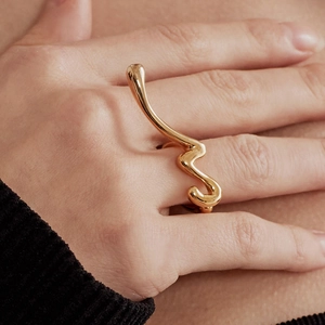 Detailed view of the 18K gold-plated irregular fluid ring on a finger with a modern style