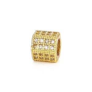 Macro shot of gold-plated hexagonal cubic bead with sparkling pavé zircon for DIY bracelets
