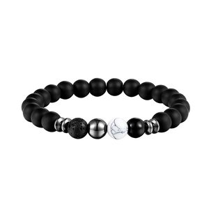 Detailed close-up of matte black natural stone yoga beads with silver metallic accents