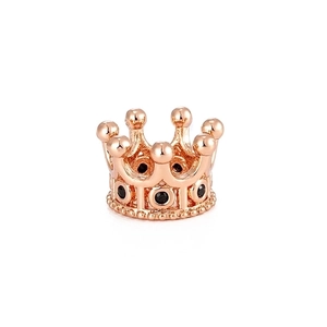 Macro detail of rose gold crown bead with micro-paved black zircon stones