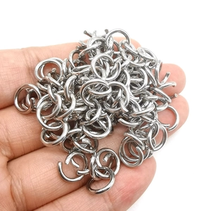 Macro shot of stainless steel open jump rings for DIY jewelry making in a hand