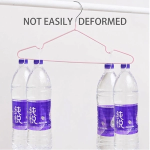 Pink non-slip metal clothes hanger demonstrating high load capacity with four water bottles