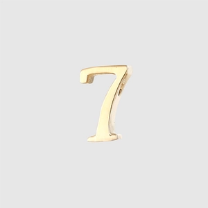 Detailed view of polished gold number 7 pendant in stainless steel with shiny finish