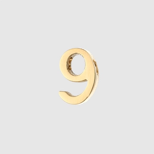 Macro shot of 6mm polished gold plated stainless steel number 9 pendant charm