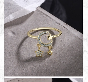 Macro detail of gold S925 silver ring featuring a diamond-set crescent moon and stars